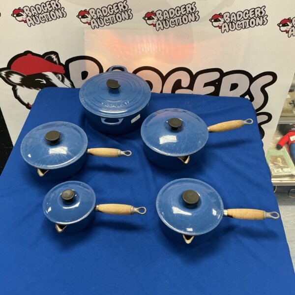 Blue Le Creuset casserole dish set on a white background.