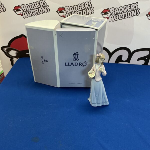 Lladro lady figurine in original box, collectible porcelain sculpture.
