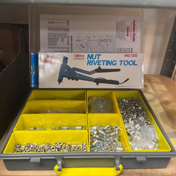 Lobster nut riveting tool with assorted rivets in storage case.