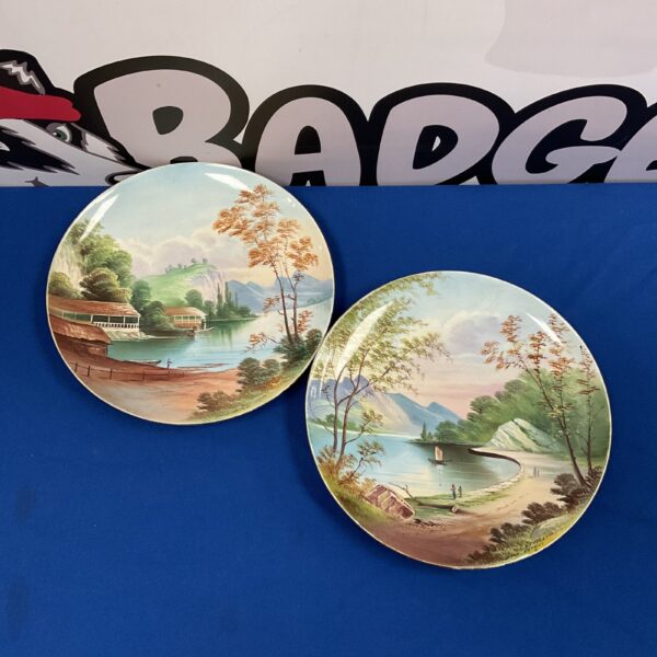 Pair of vintage hand-painted Loch Katrine plates with scenic landscapes.