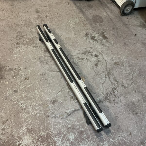 Lockable car roof bars in used condition, ideal for vehicle transport.