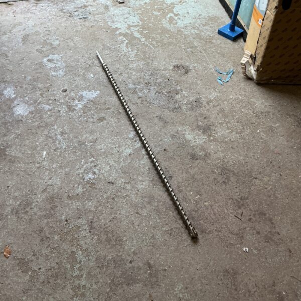 Long metal drill bit with twisted flute design.