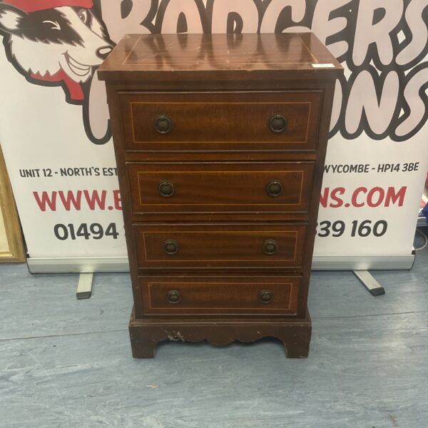Vintage mahogany chest of four drawers with a warm tone.