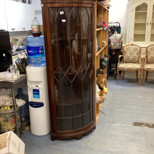 Large mahogany corner display cabinet with glass front.