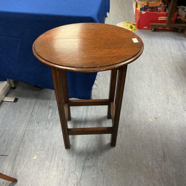 Antique mahogany hall table with oval top and turned legs.