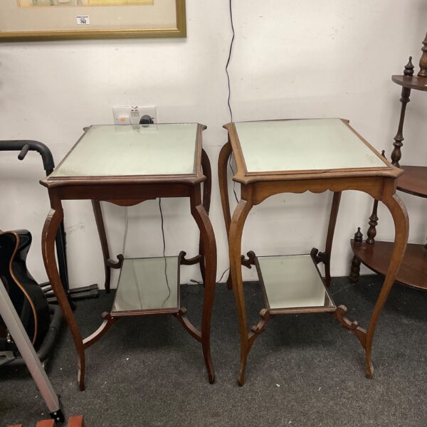 Pair of antique mahogany lamp tables with mirrored tops.