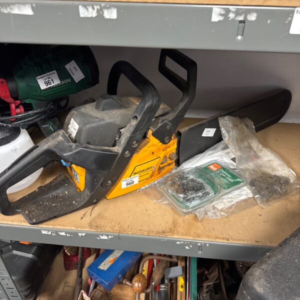 Vintage McCulloch petrol chainsaw with spare chains for garden and DIY.