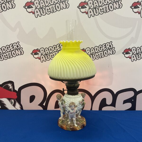 Antique Meissen porcelain oil lamp with cherub figurine.