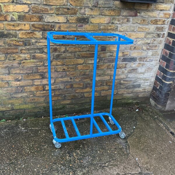 Vintage metal bag trolley with wheels for easy transport.