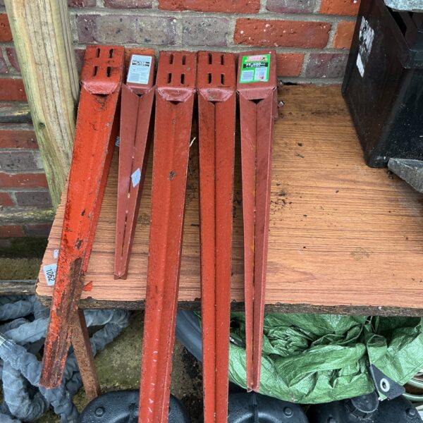 Five metal fence post fixers for garden fencing.