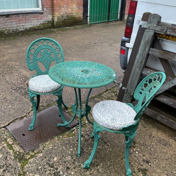 Vintage metal garden furniture set with table and two chairs.