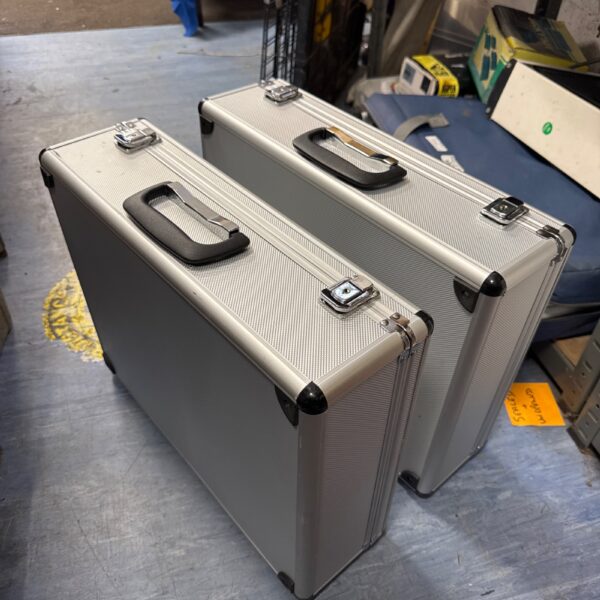 Two metal transit cases with handles, ideal for equipment transport.