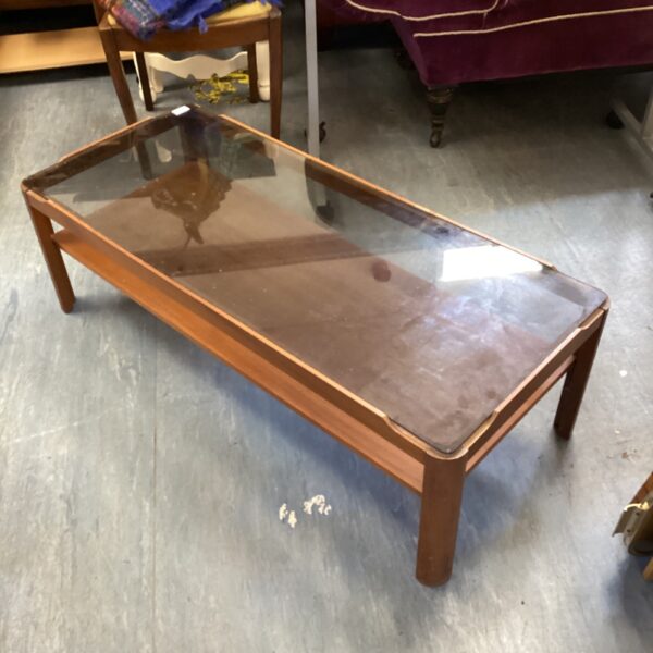 Vintage mid-century mahogany coffee table with glass top.