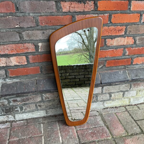Vintage mid-century teak mirror with angled design.