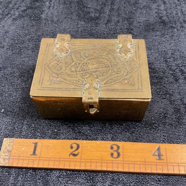 Vintage Middle Eastern brass box with detailed embossed patterns.
