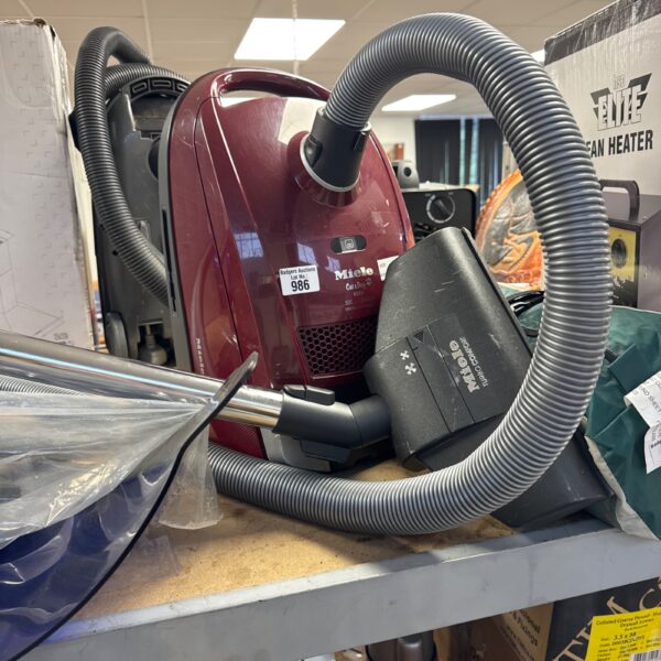 Red Miele Cat & Dog 6000 vacuum cleaner for pet hair removal.