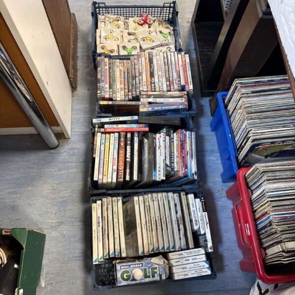 Mixed media lot with video games, DVDs, and fidget spinners.