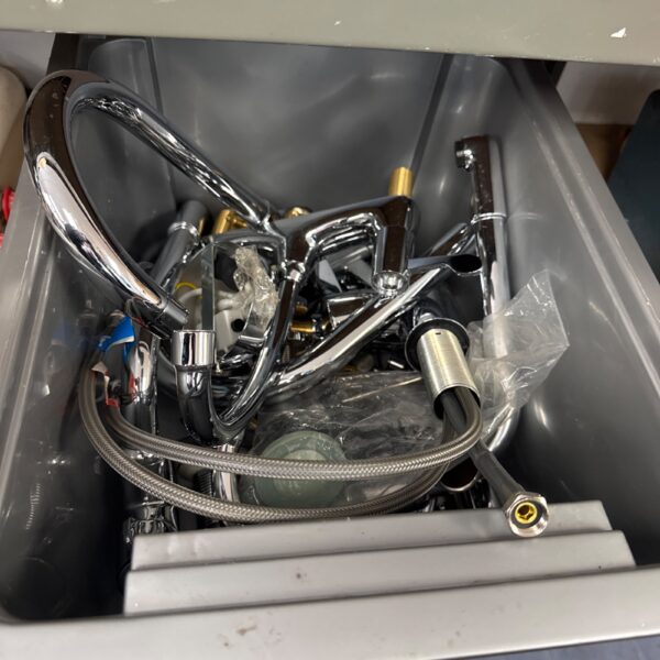 Mixed lot of chrome and brass taps for plumbing projects.
