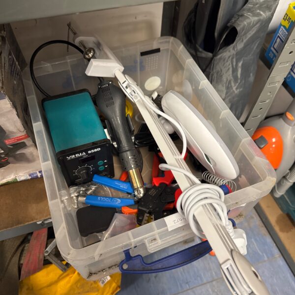 Tray of mixed tools including soldering iron and magnifying lamp.