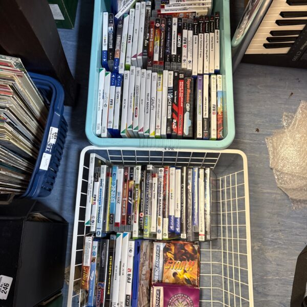 Tray of mixed retro video games for multiple consoles.