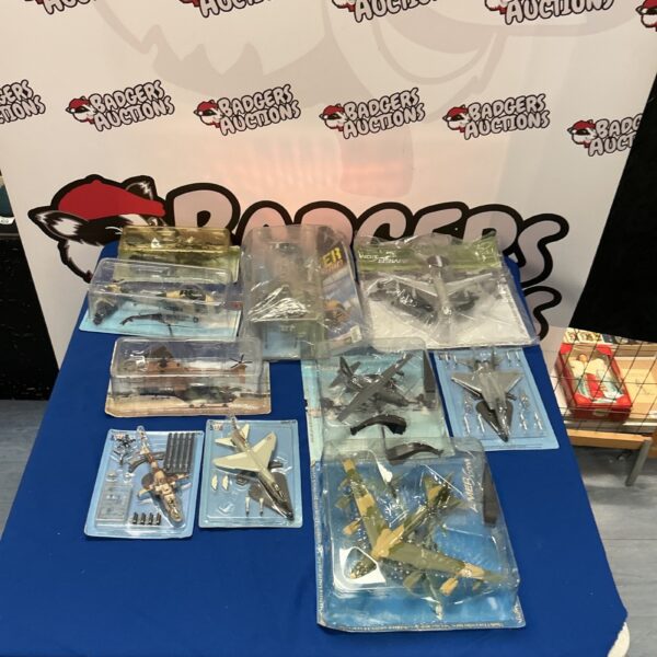 Collection of model aircraft in packaging, aviation collectibles.