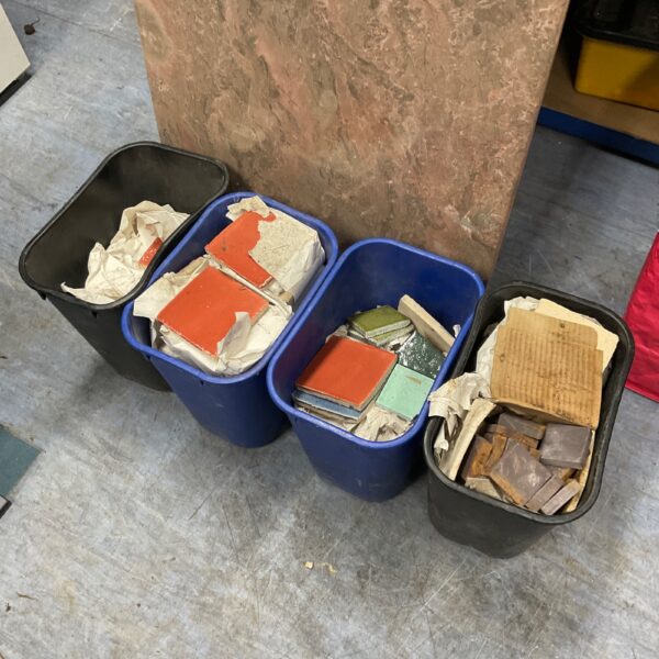 Mixed mosaic tiles in tubs, ideal for crafting projects.