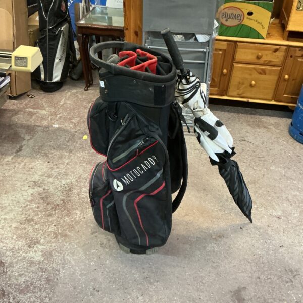 Motocaddy golf bag with umbrella, showing signs of use.