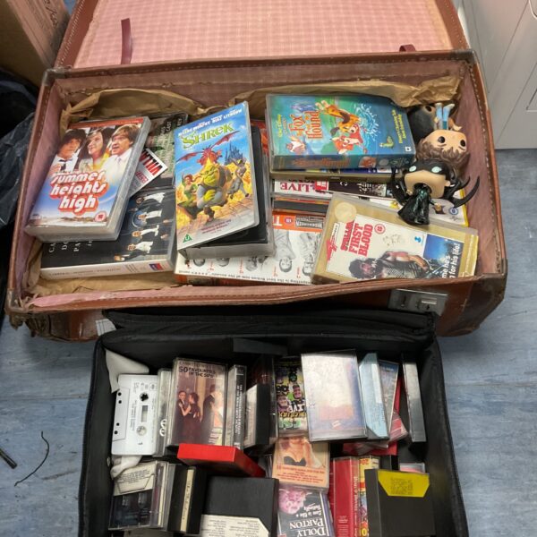 Vintage suitcase filled with a movie and tape lot.