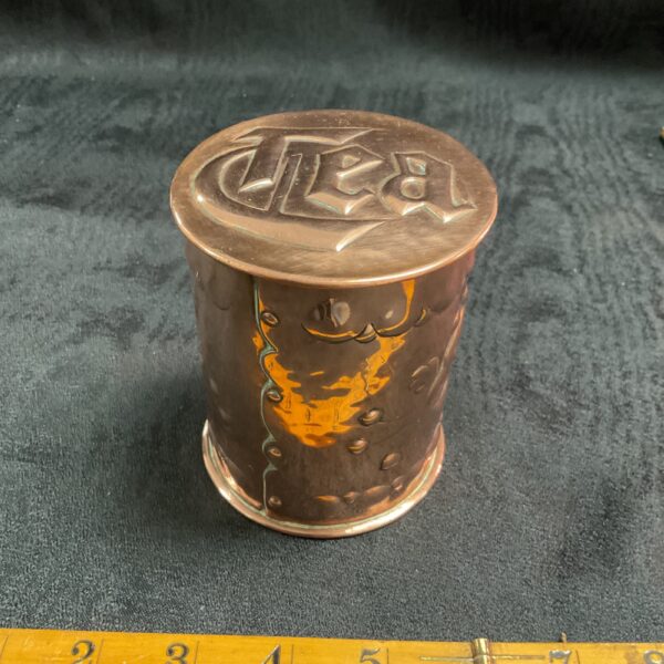 Antique Newlyn copper teacaddy with detailed floral repoussé.