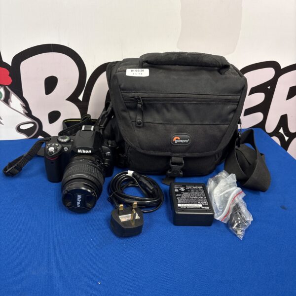 Nikon D40 digital camera with case and lens, photography equipment.
