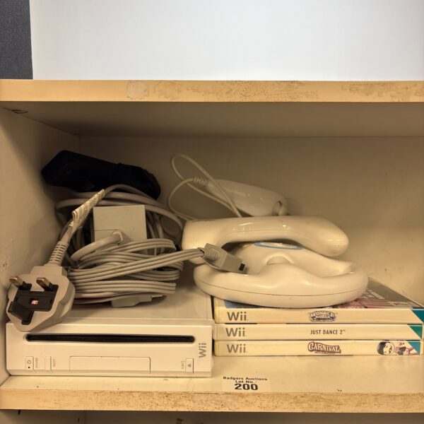 Nintendo Wii console with games and leads presented for auction.