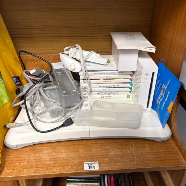 Nintendo Wii console with games and accessories displayed.