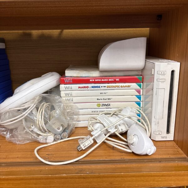 Nintendo Wii console with games and accessories displayed.