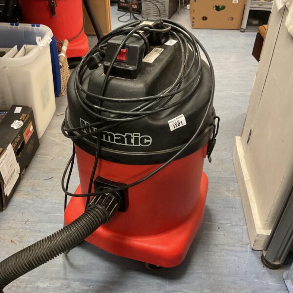 Red Numatic industrial vacuum cleaner with flexible hose.
