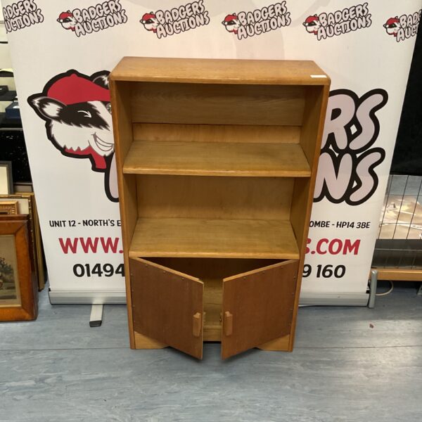 Vintage oak cupboard with internal shelving for storage.