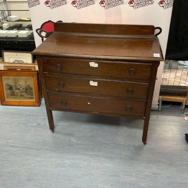 Antique oak three-drawer dresser with a warm wood finish.