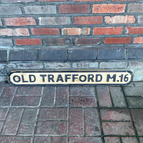 Vintage wooden Old Trafford street sign for football fans.