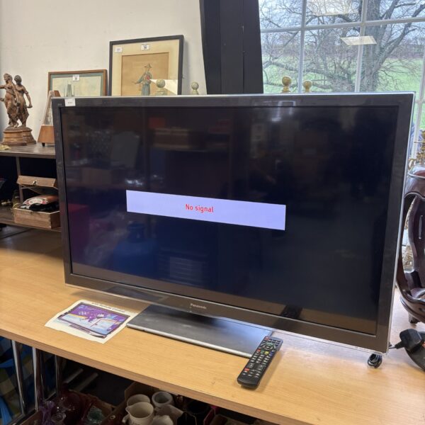 Panasonic 42 inch flatscreen TV with remote control for home entertainment.