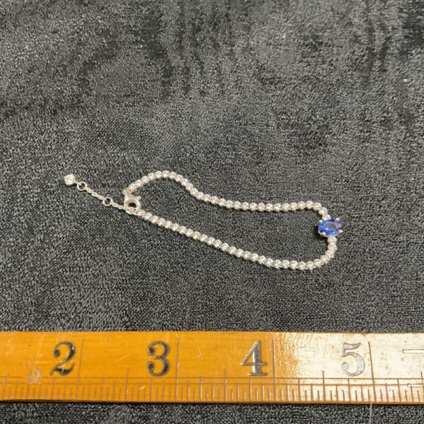 Pandora silver bracelet with whitestone and sapphire details.