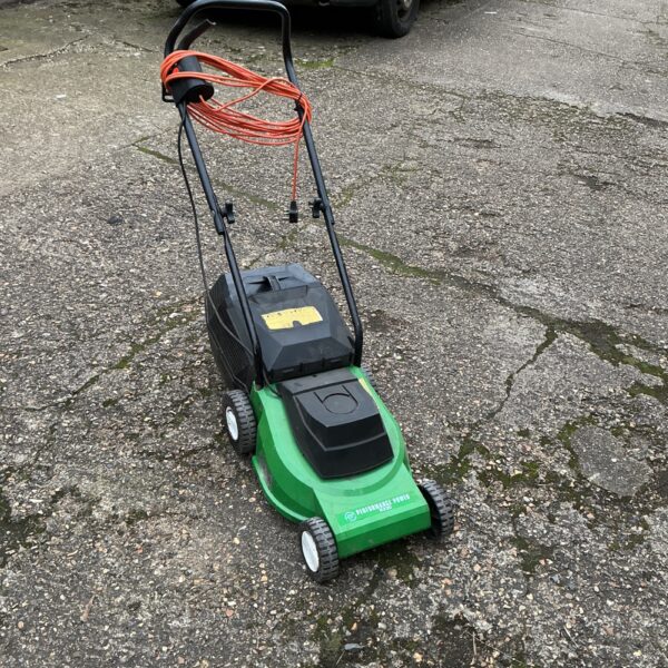 Green and black Performance electric lawn mower in a garden setting.