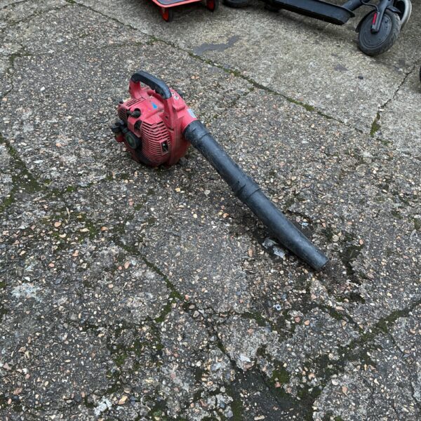 Used handheld petrol leaf blower for garden maintenance.