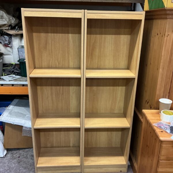 Pair of pine shelf units for home storage and display.