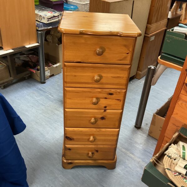 Vintage pine six-drawer chest for bedroom storage.