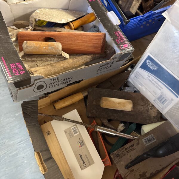 Vintage lot of plasterers hawks and trowels for building work.