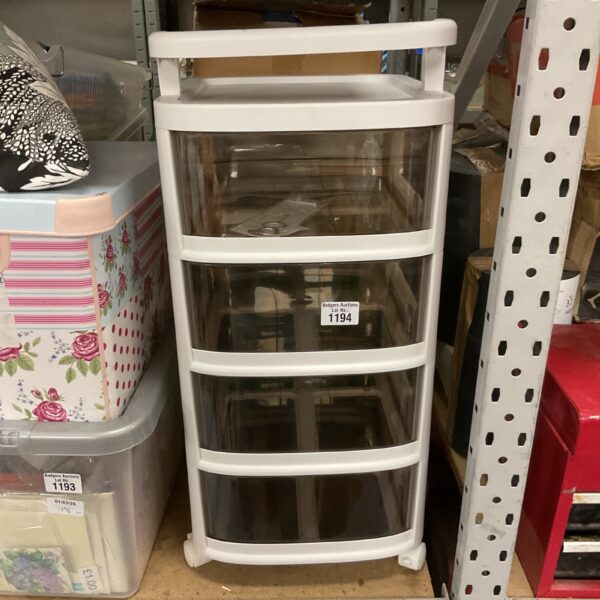 White plastic storage unit with four drawers on wheels.
