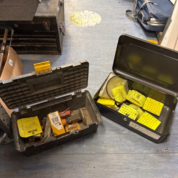 Vintage plastic toolbox and metal lockbox with contents for storage.