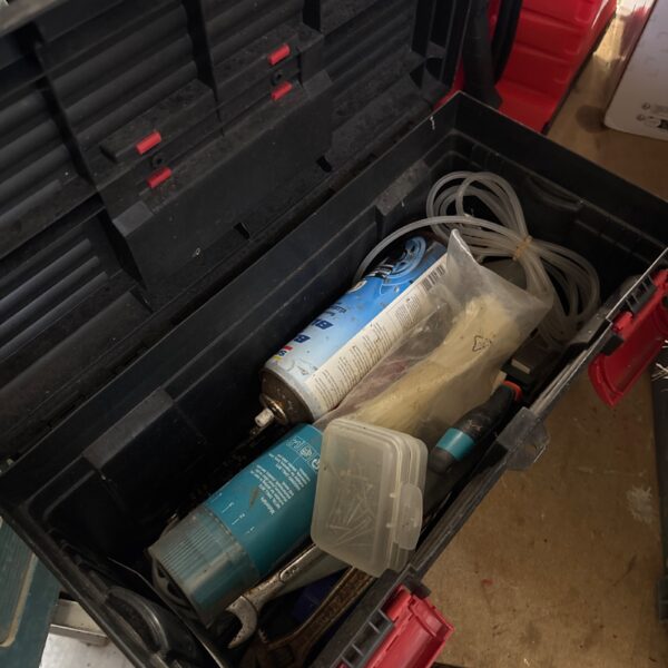 Medium-sized plastic toolbox filled with various tools and items.