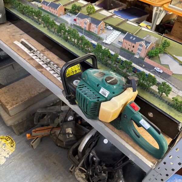 Used Qualcast petrol hedge trimmer for garden landscaping.