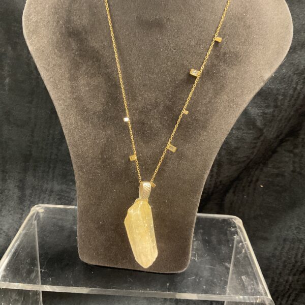 Natural quartz crystal pendant on gold plated necklace.