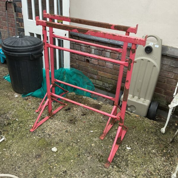 Red metal builders trestles for construction and DIY projects.